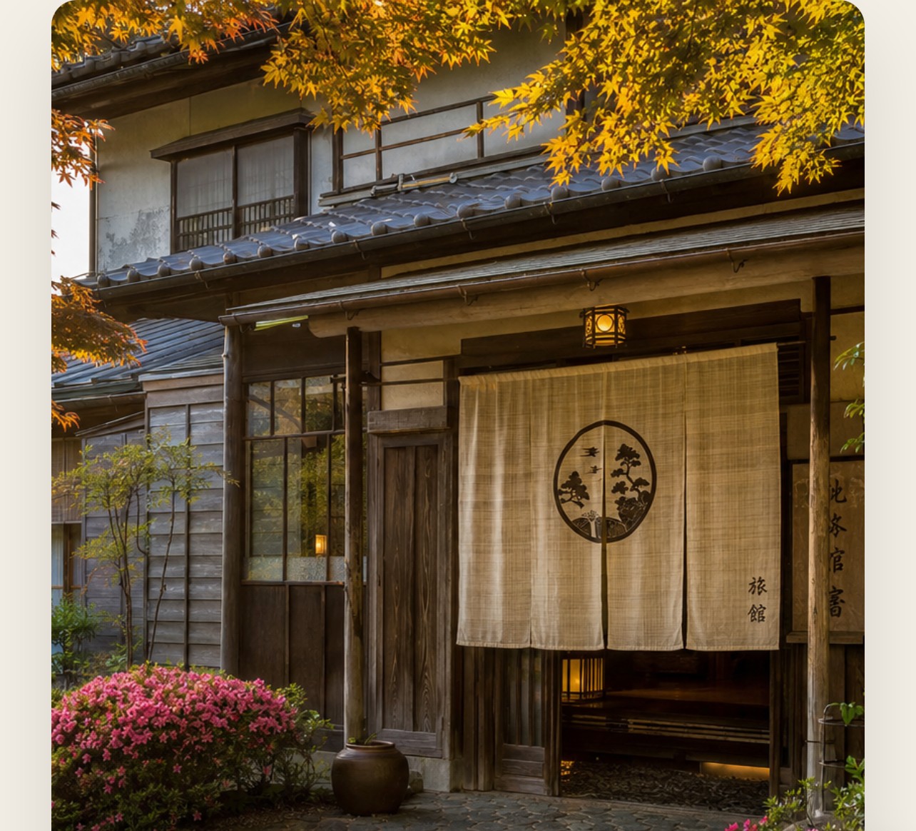 Historic exterior of Shiraume Lodge with noren curtain entrance and autumn maple trees